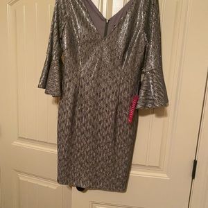Silver/gray sequin dress with V-neck and bell sleeves.
